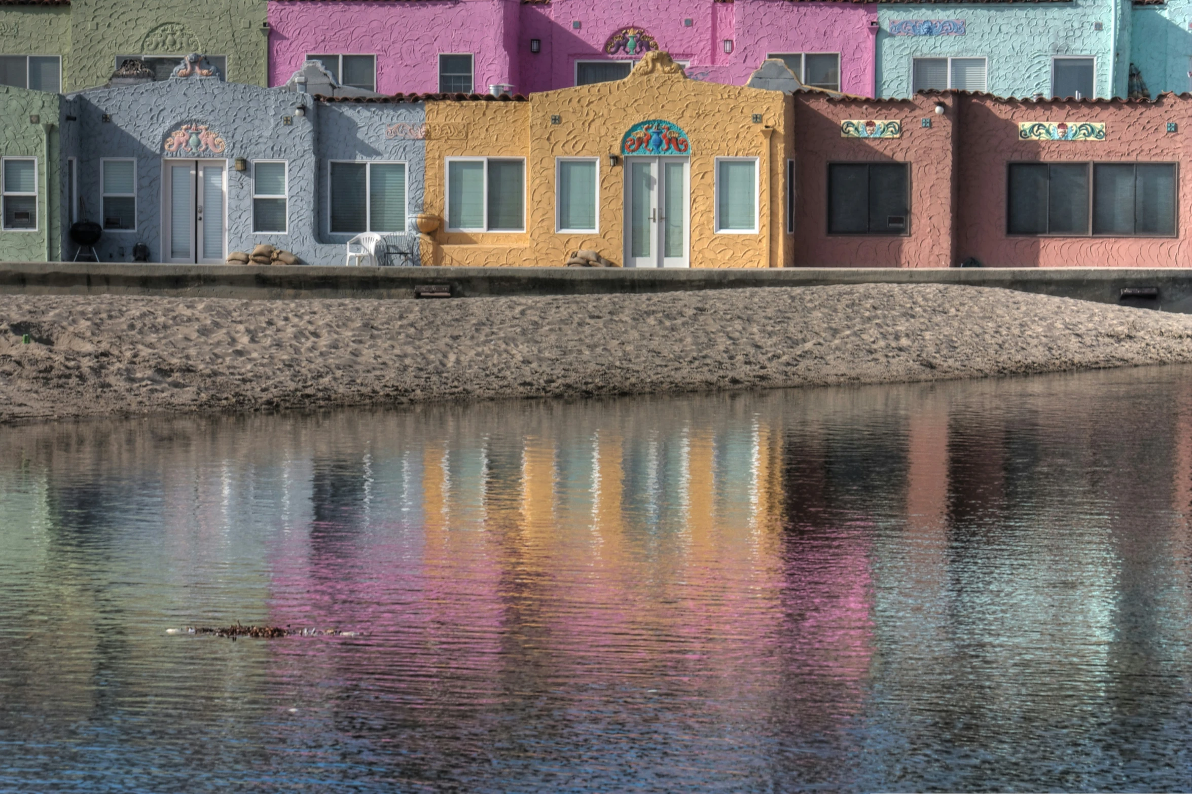 buildings near the water with a large amount of sand