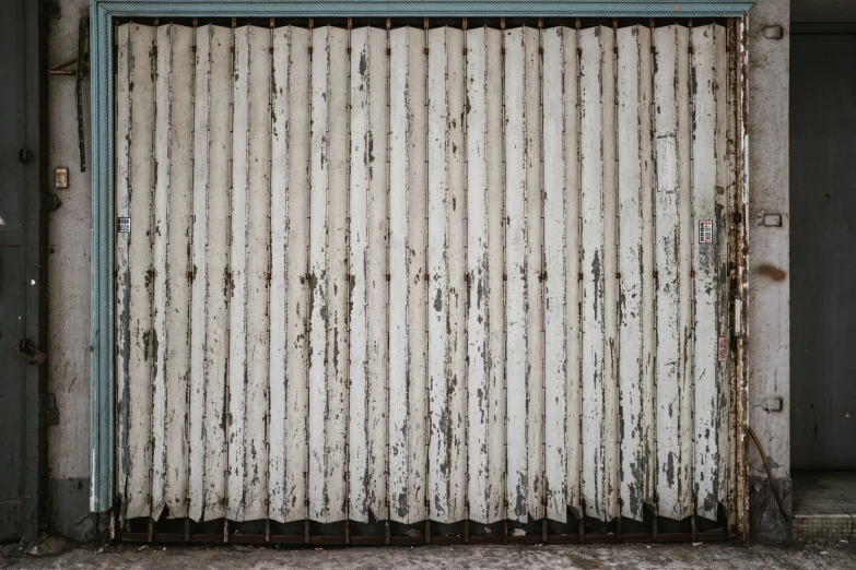 the gate to an old building with peeling paint