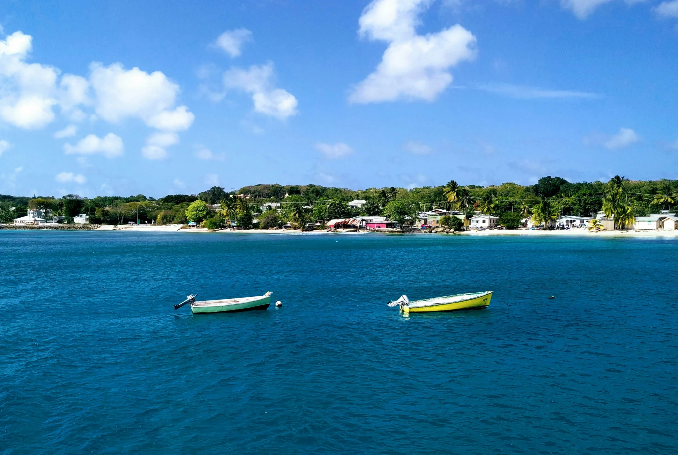 two boats on the sea near a beach