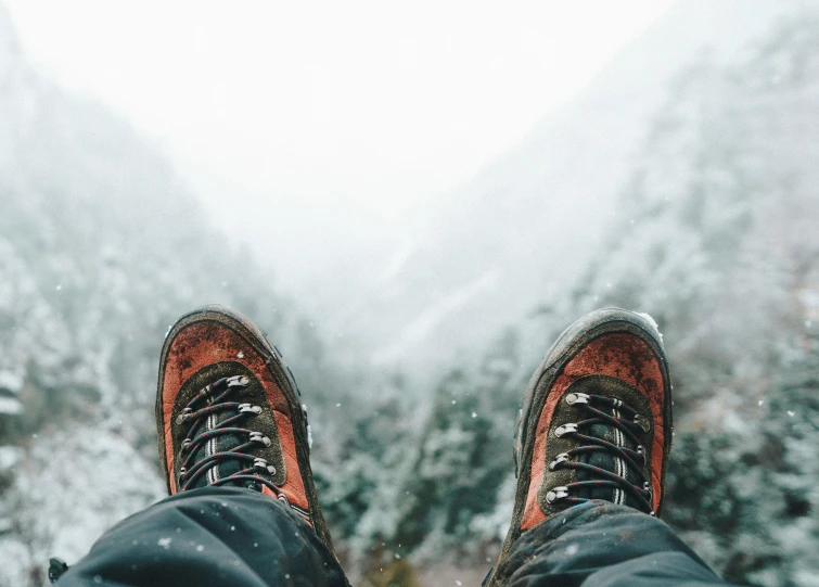 person standing in front of trees with boots on