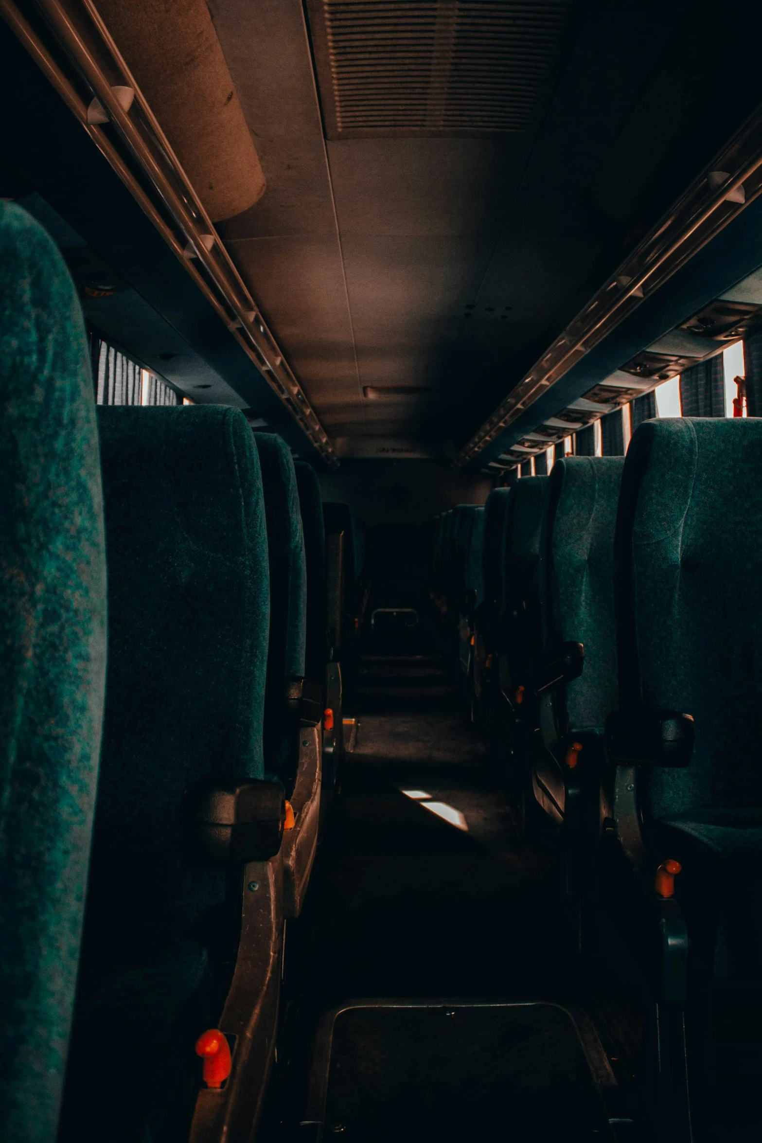 the empty seats of an airplane in the dark