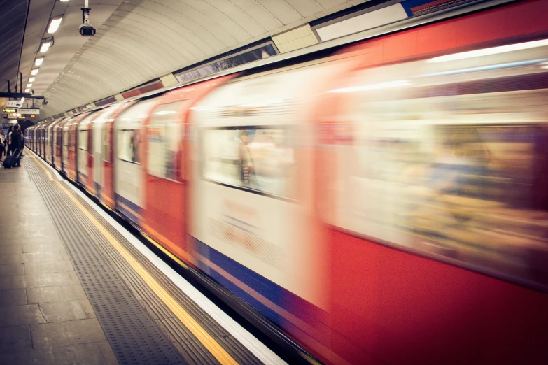 a subway with a train passing by it