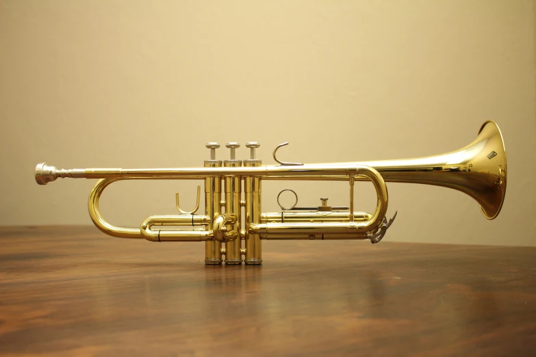 a trumpet sitting on top of a wooden table