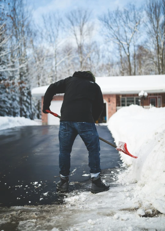 a person shoveling snow from a curb