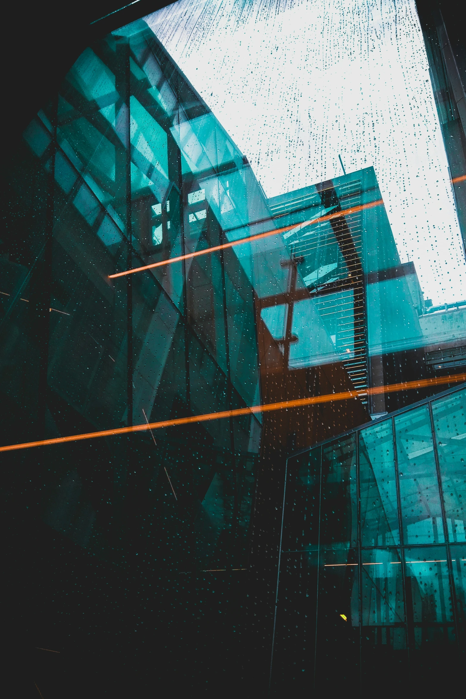 a view from below of a building through the windshield of a car