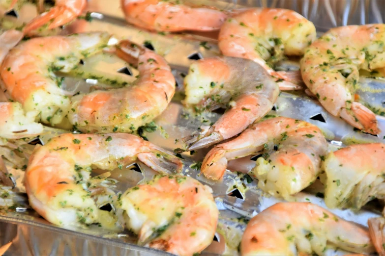 cooked seafood in a pan covered with parsley and pepper