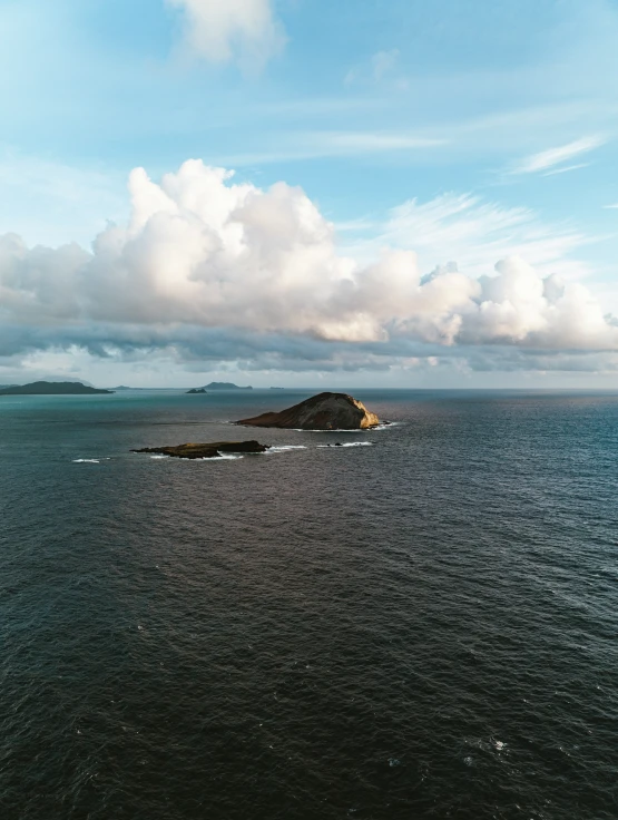 some white clouds and some blue water