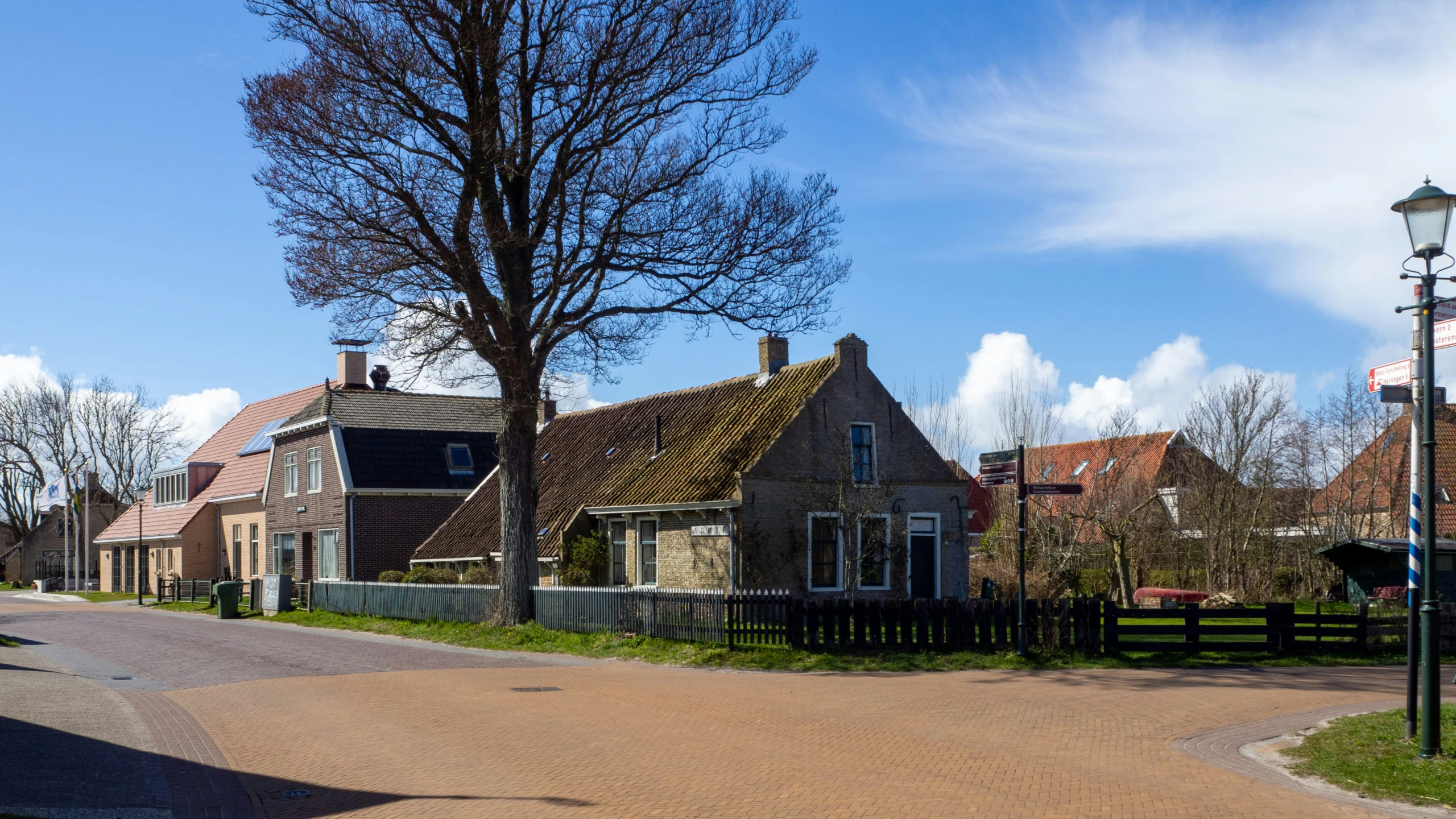 the brick town is lined with three old houses