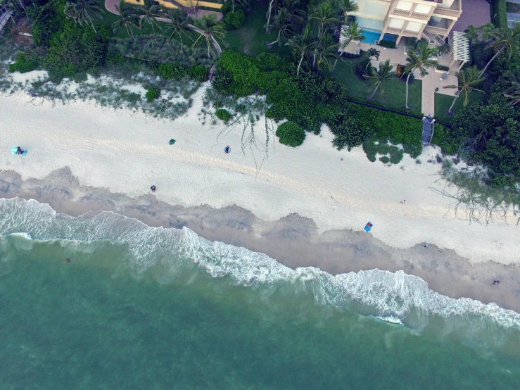 an aerial po of an island beach next to the ocean