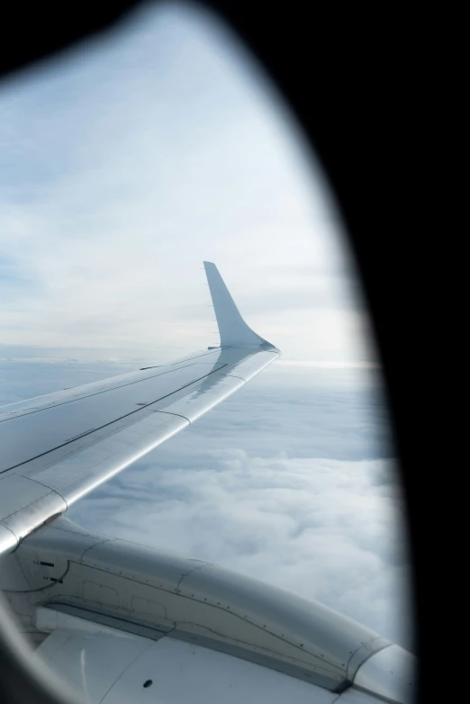 the view out the airplane window shows a view on a wing