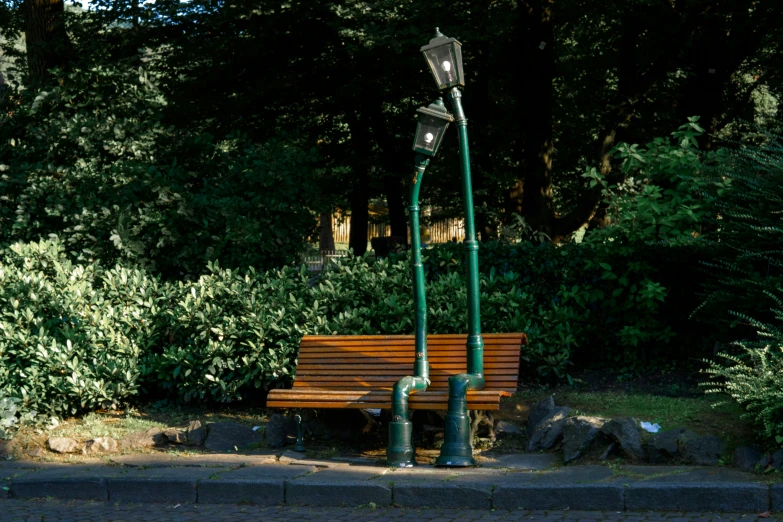 a park bench sitting under a street lamp