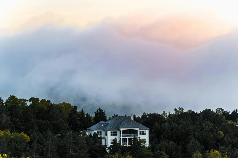 a house in a forested area in the early evening