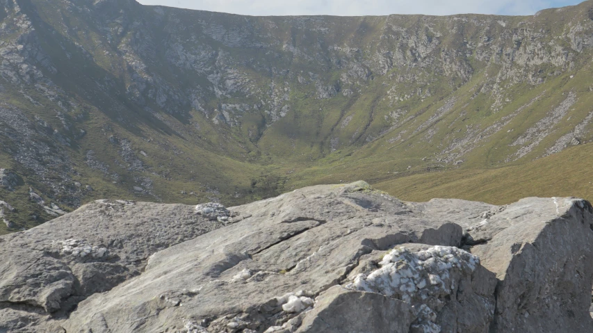 a person climbing up a hill in the mountains