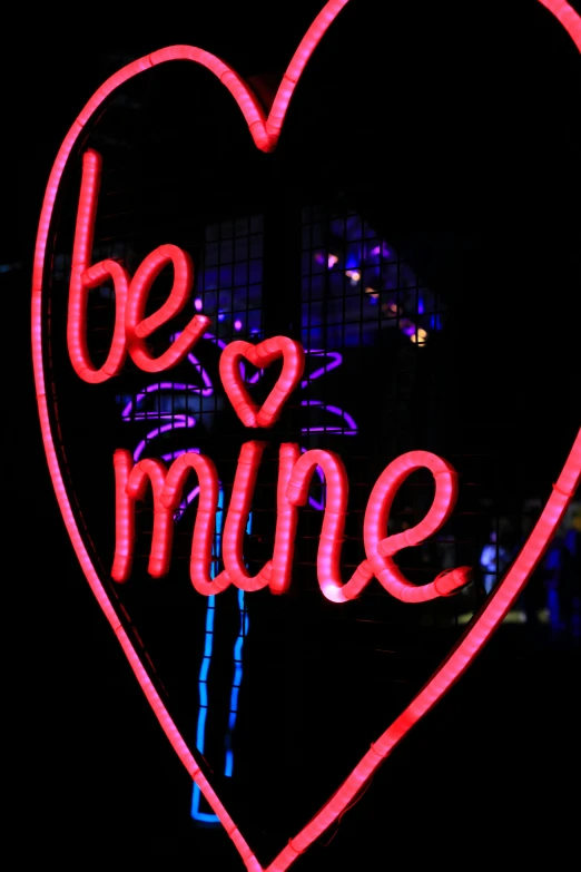 large neon sign that says be mine