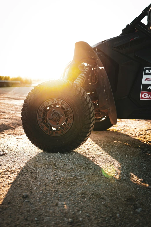 a big tire on the road by some cars