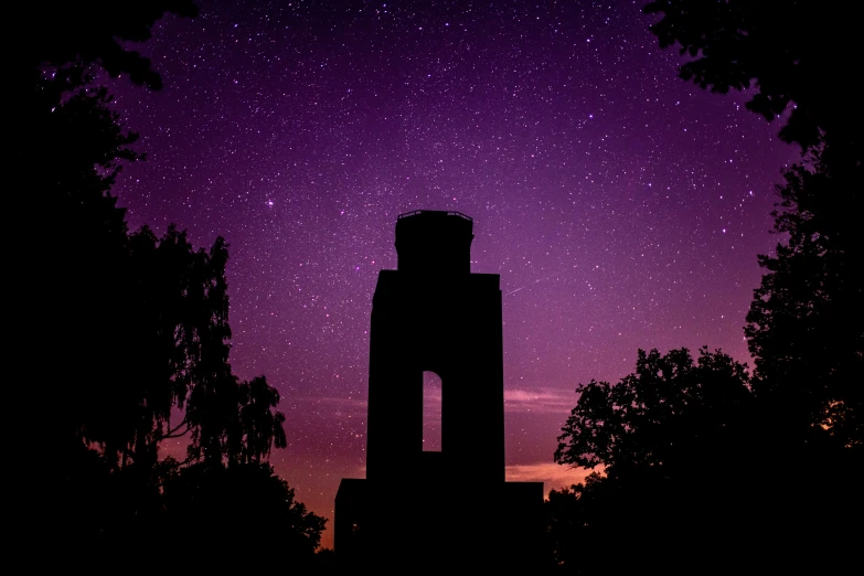 night scene of the night sky with bright stars above an old stone building