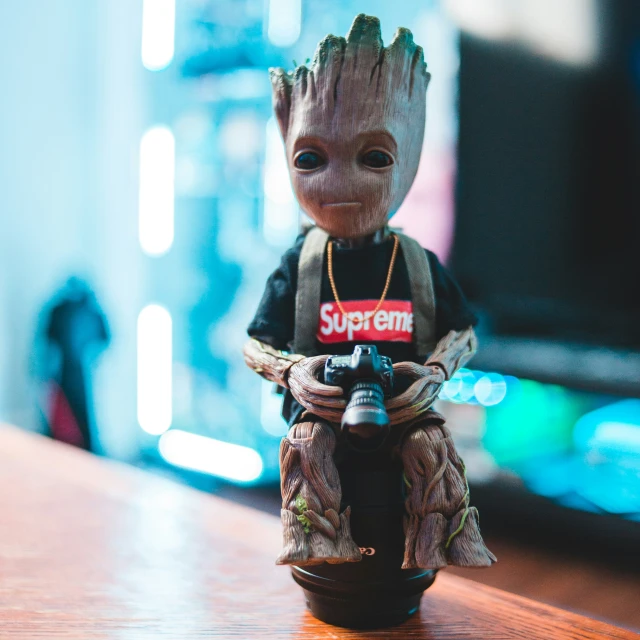 an action figure sitting on top of a wooden table