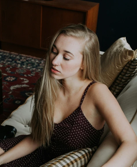 a young woman in the middle of her body resting on the couch