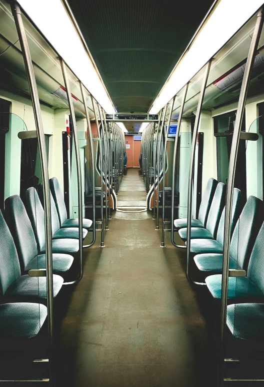 an empty subway car with blue seats on each side