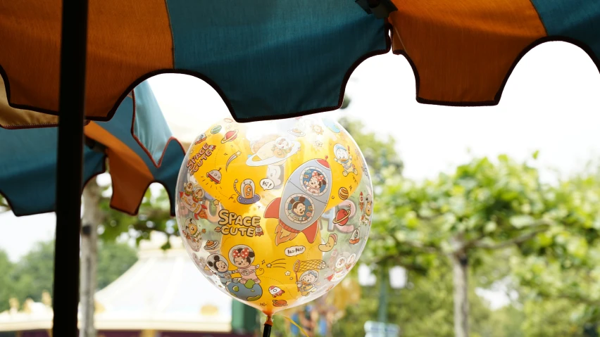 a balloon has pictures of various types of things hanging from it