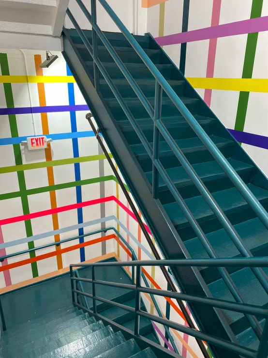 a staircase in a public building with multiple colored lines