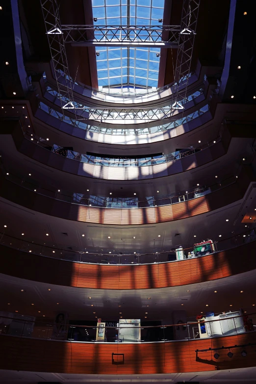 a clock is mounted to the ceiling in a circular building