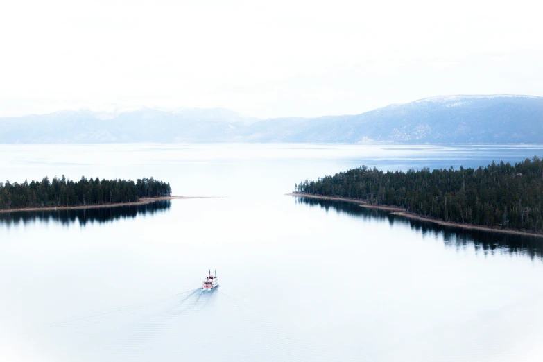 two people in a small boat on a large body of water