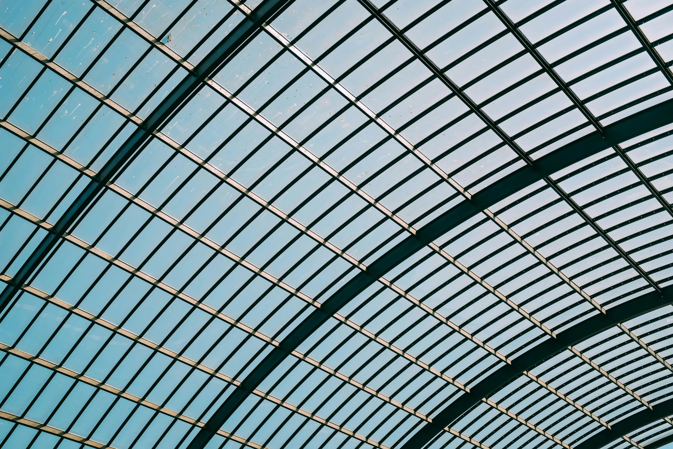 a train station with the roof and blue sky as background