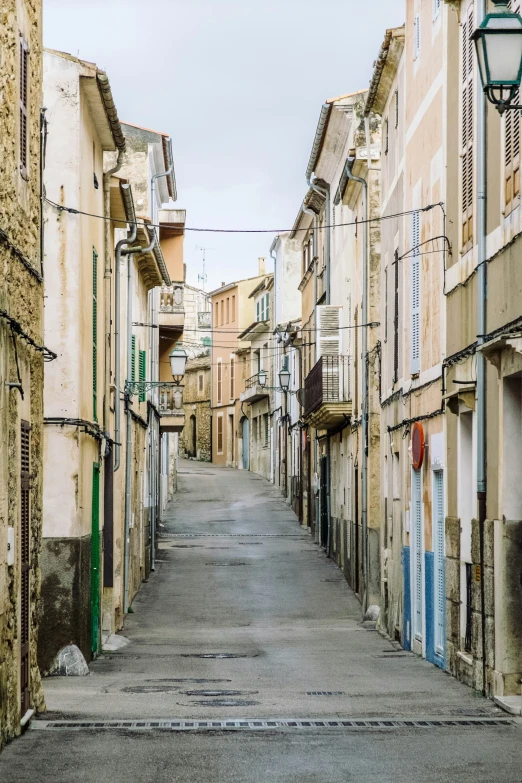 a empty street with buildings and windows on both sides