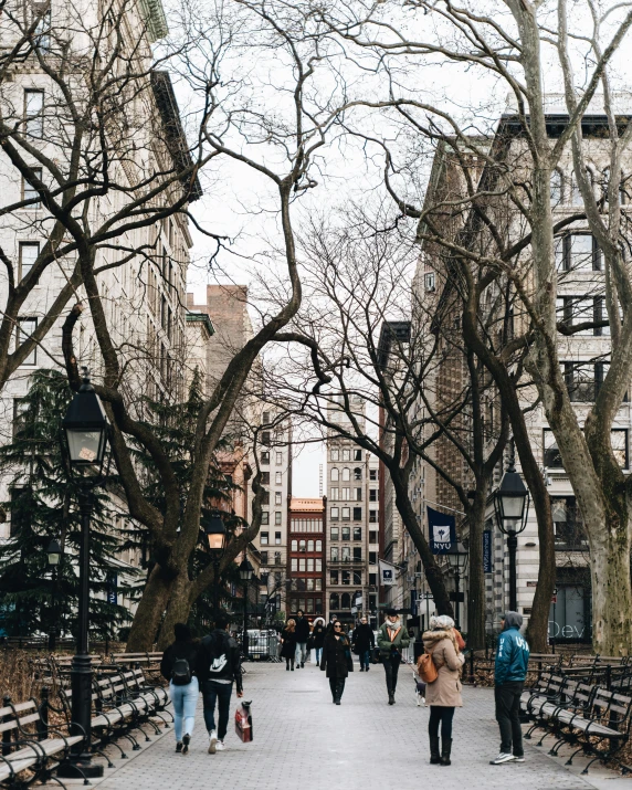 a group of people walking down a sidewalk