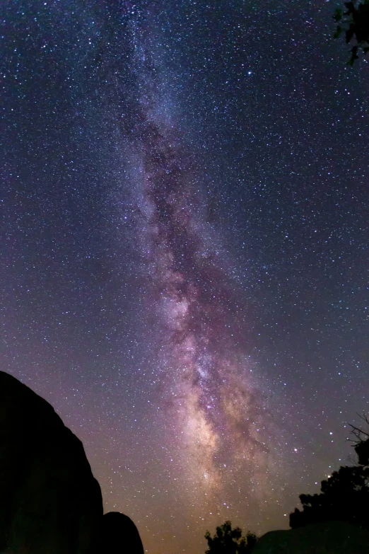 the milky shines brightly above the rocks