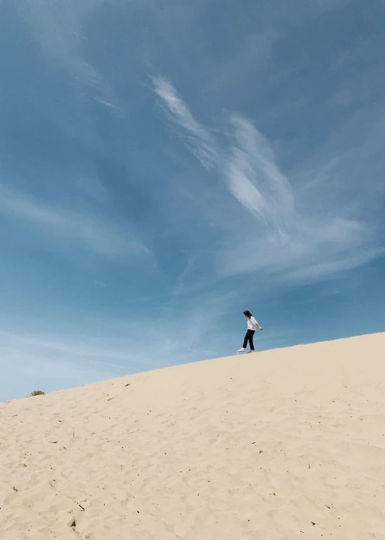 the boy is walking on the beach alone