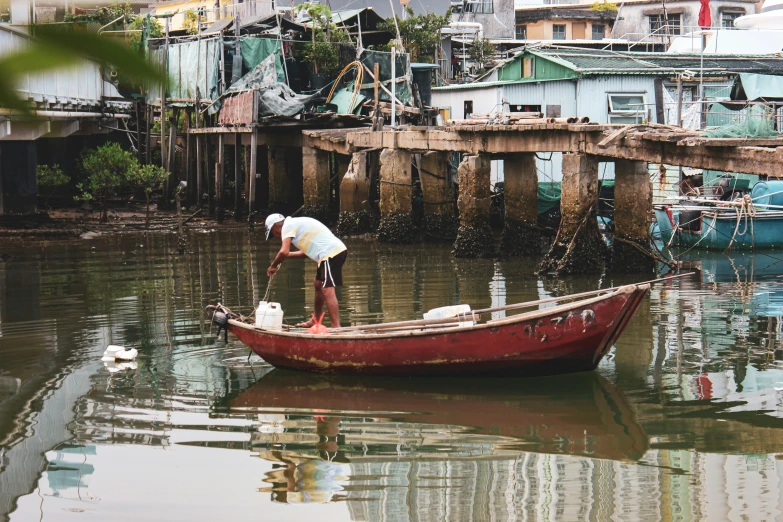 a man with fishing gear is cleaning the boats