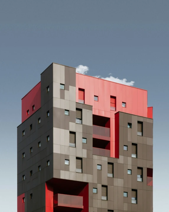 the multi - colored building has windows and many balconies