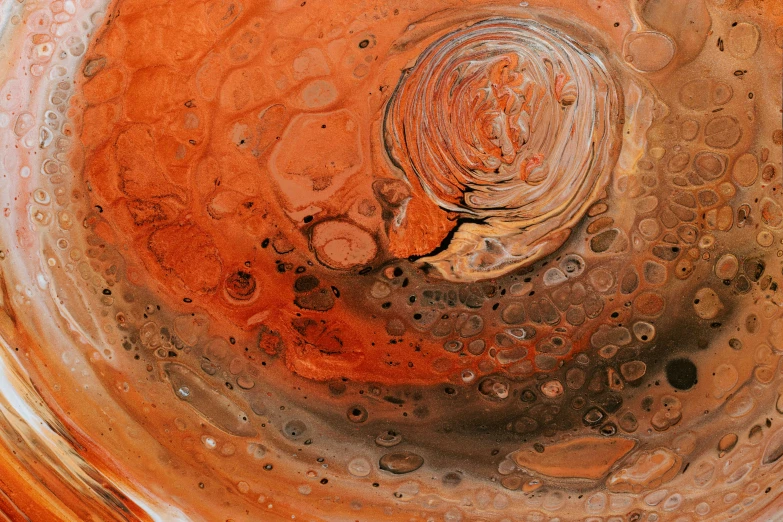 some brown, yellow and white liquid inside a bowl