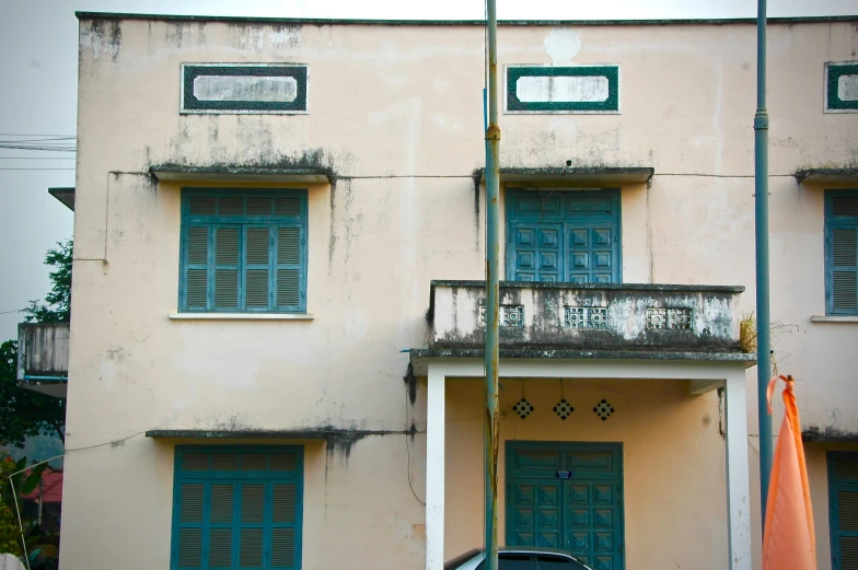 two windows with blue shutters on the top and bottom