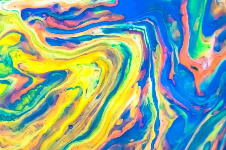 colored fluide is flowing down a colorful background