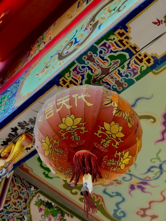 red paper lanterns are hanging from a ceiling