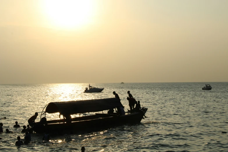 a boat in the water with some people around