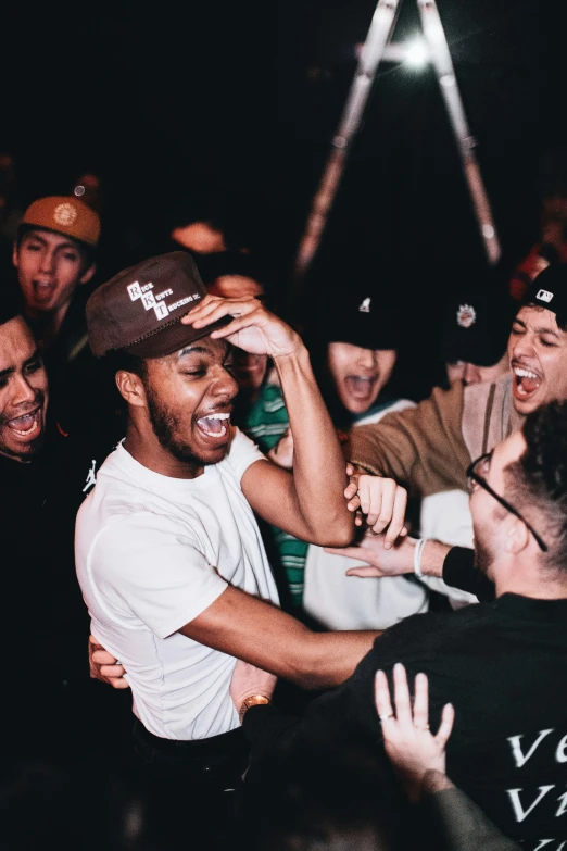 young men are in a crowd playing with each other