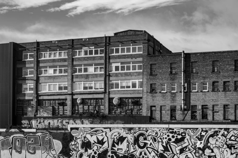 black and white image of apartment building with graffiti on wall