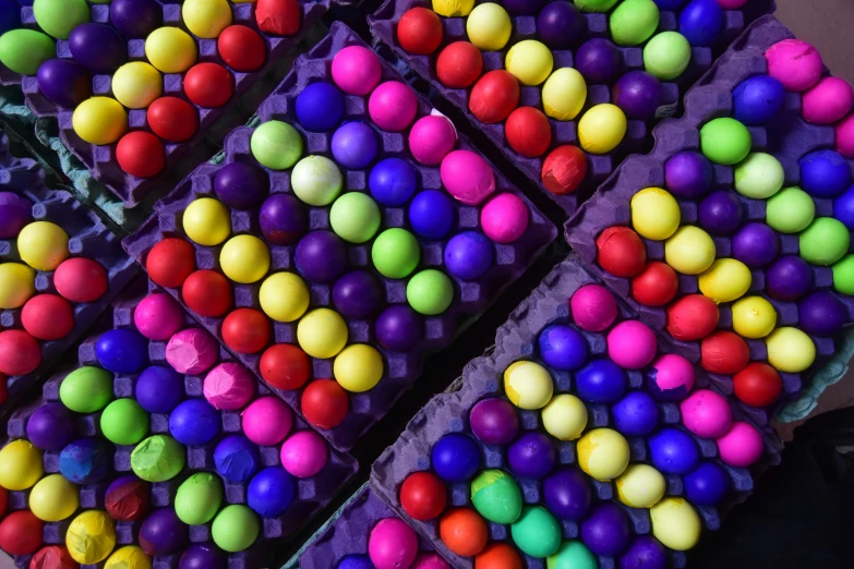 various color balls are lined up on trays