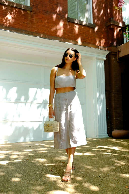 a young woman in a cropped tank top and linen culots