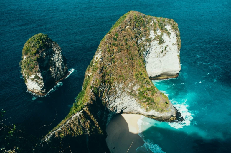 an island with two white cliffs next to the water