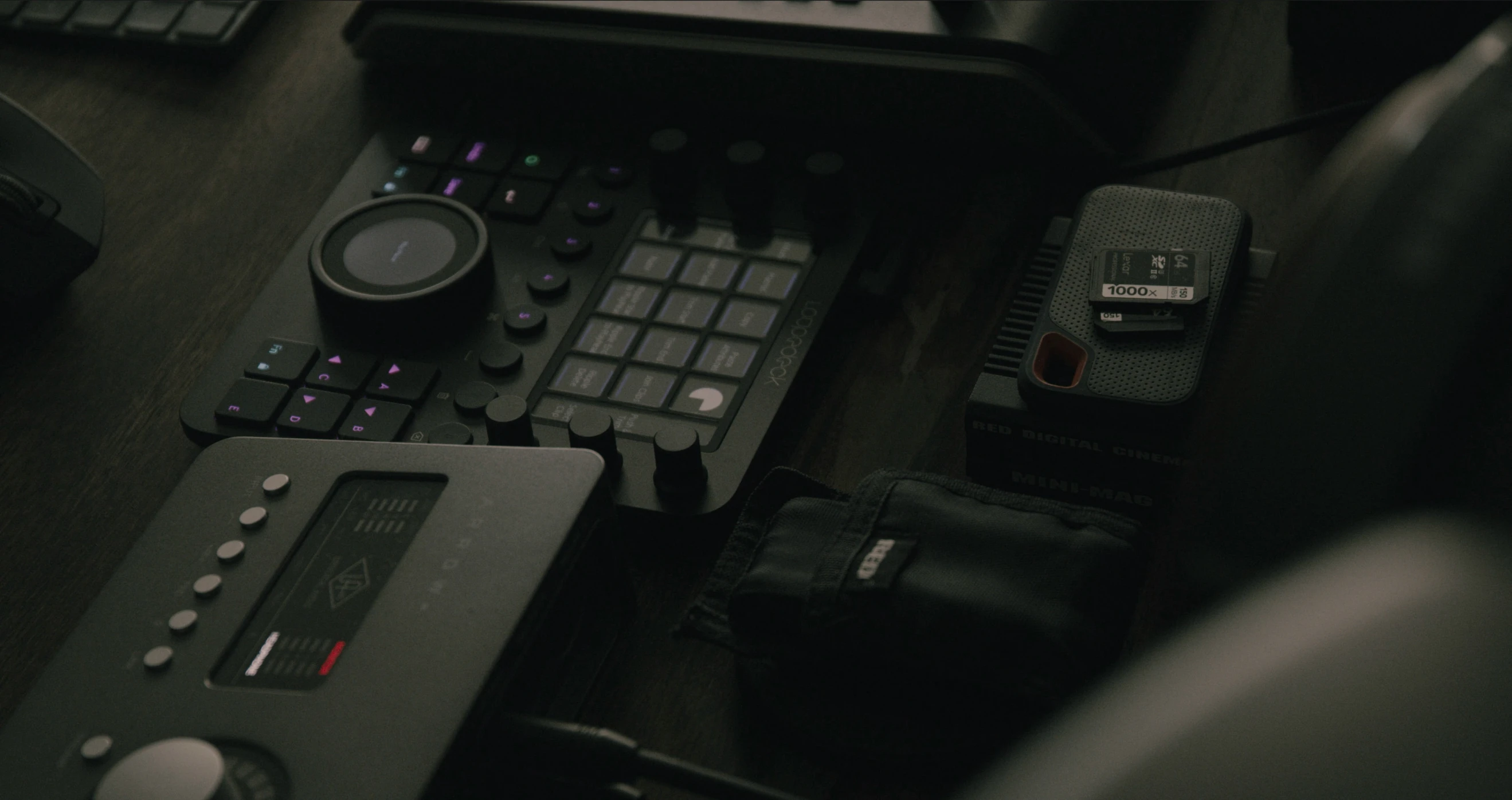 a set up with a black keyboard, various ons, speakers and mouse pads