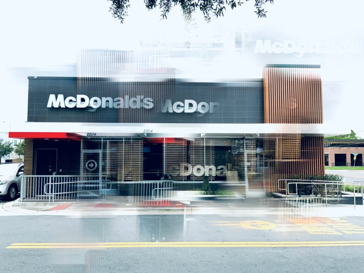 the front of a mcdonalds with a reflection of it