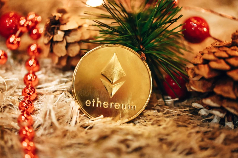 a gold ethereum coin resting on a table next to pine cones