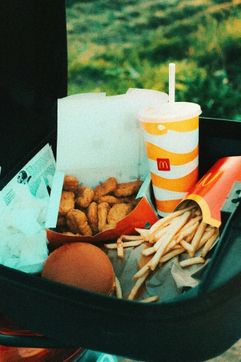 a basket filled with french fries, ketchup, and a drink