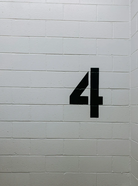 a white brick wall with an arrow pointing to the 4