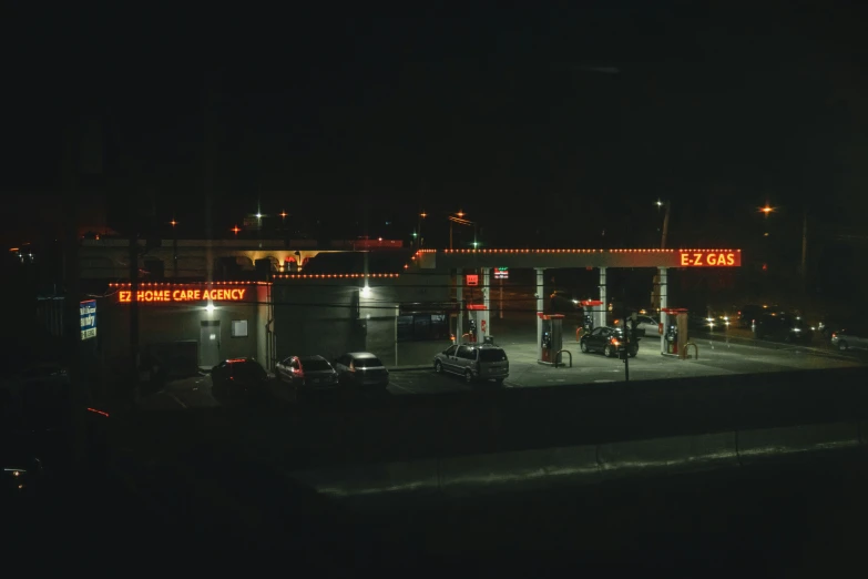 an industrial gas station lit up in the night time